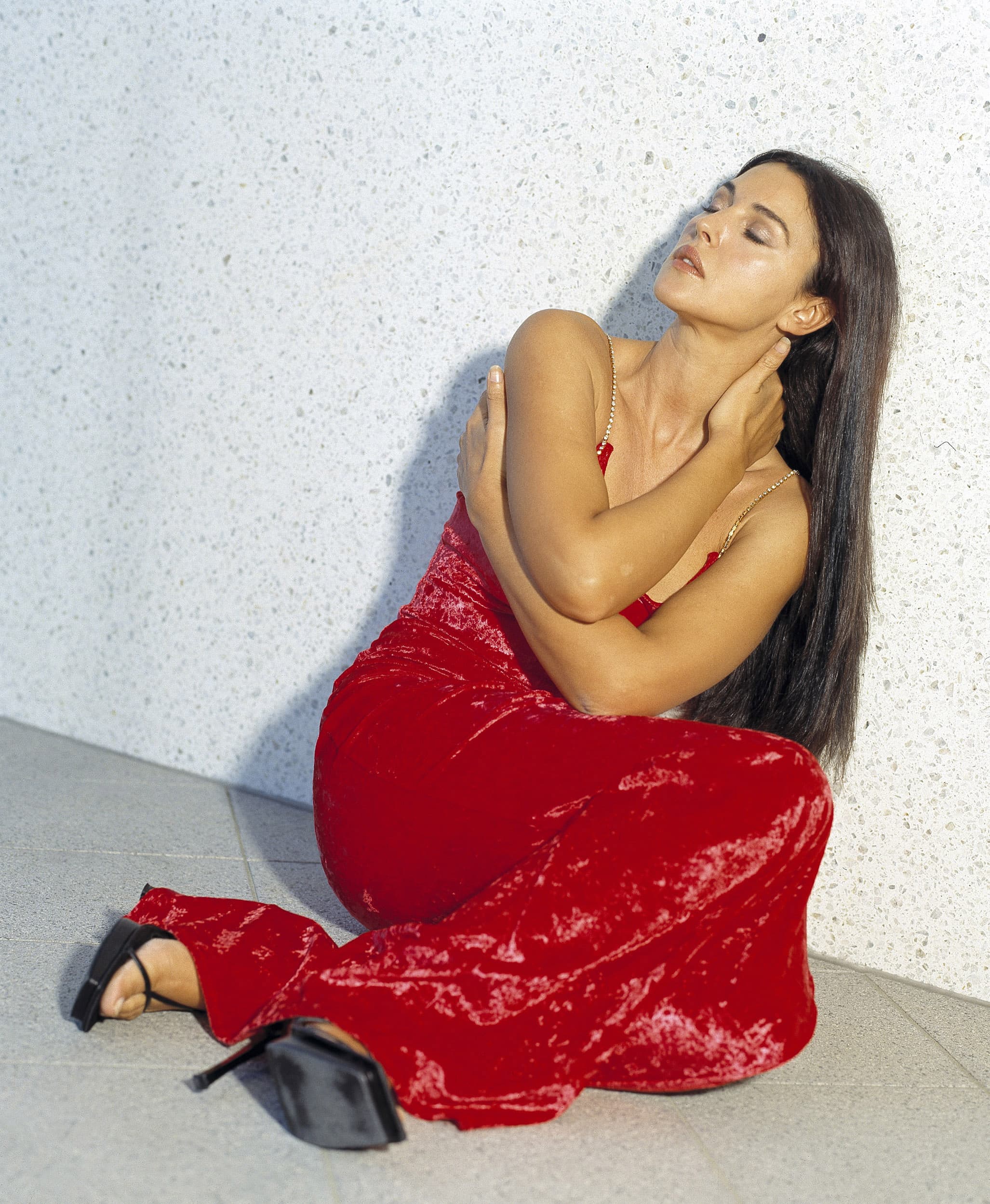The red dress and understated setting create a striking contrast in Patrick's composition.