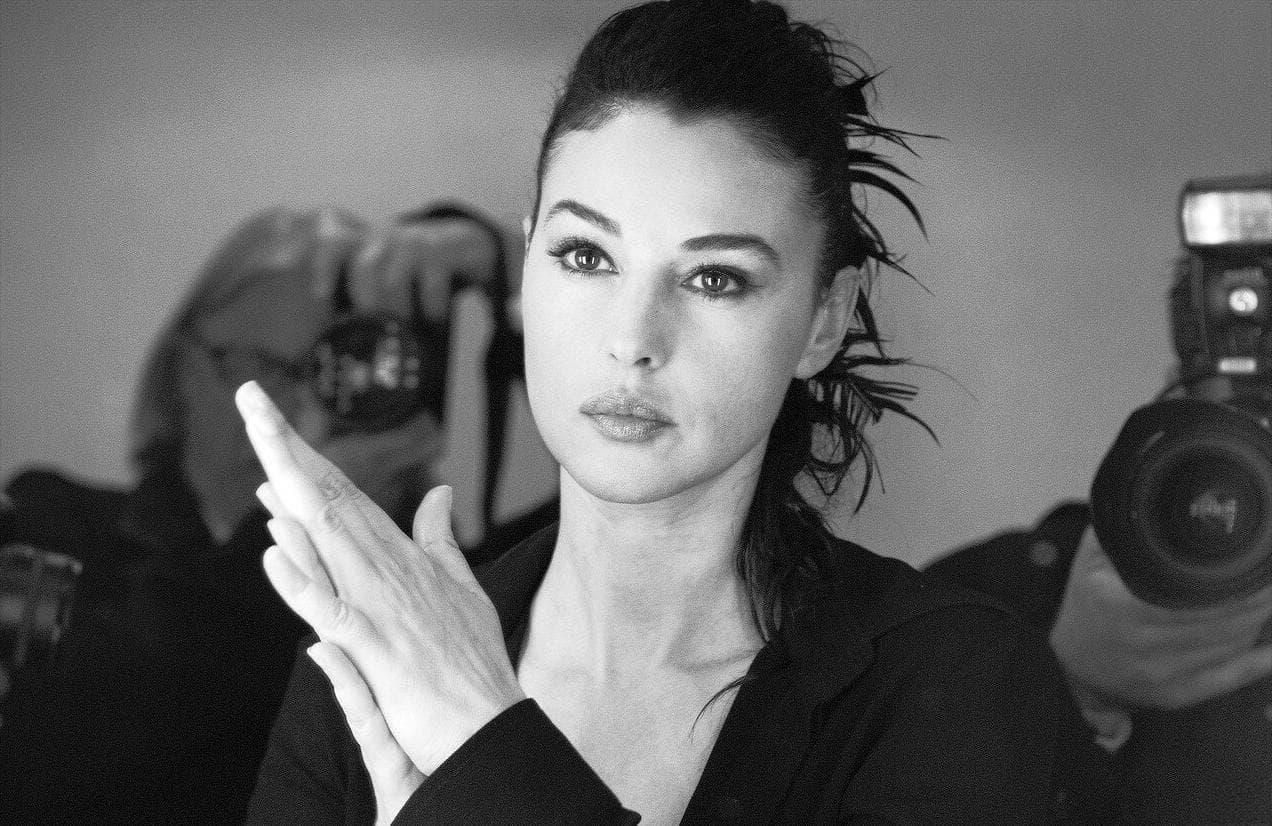 Bellucci pauses backstage as photographers document the preparations surrounding her role as mistress of ceremonies.