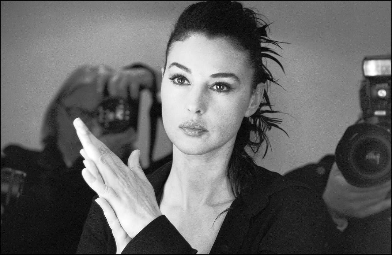 Bellucci pauses backstage as photographers document the preparations surrounding her role as mistress of ceremonies.