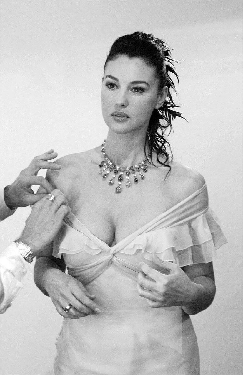 Her pale Dior Haute Couture gown is carefully adjusted in the dressing room before the closing ceremony.