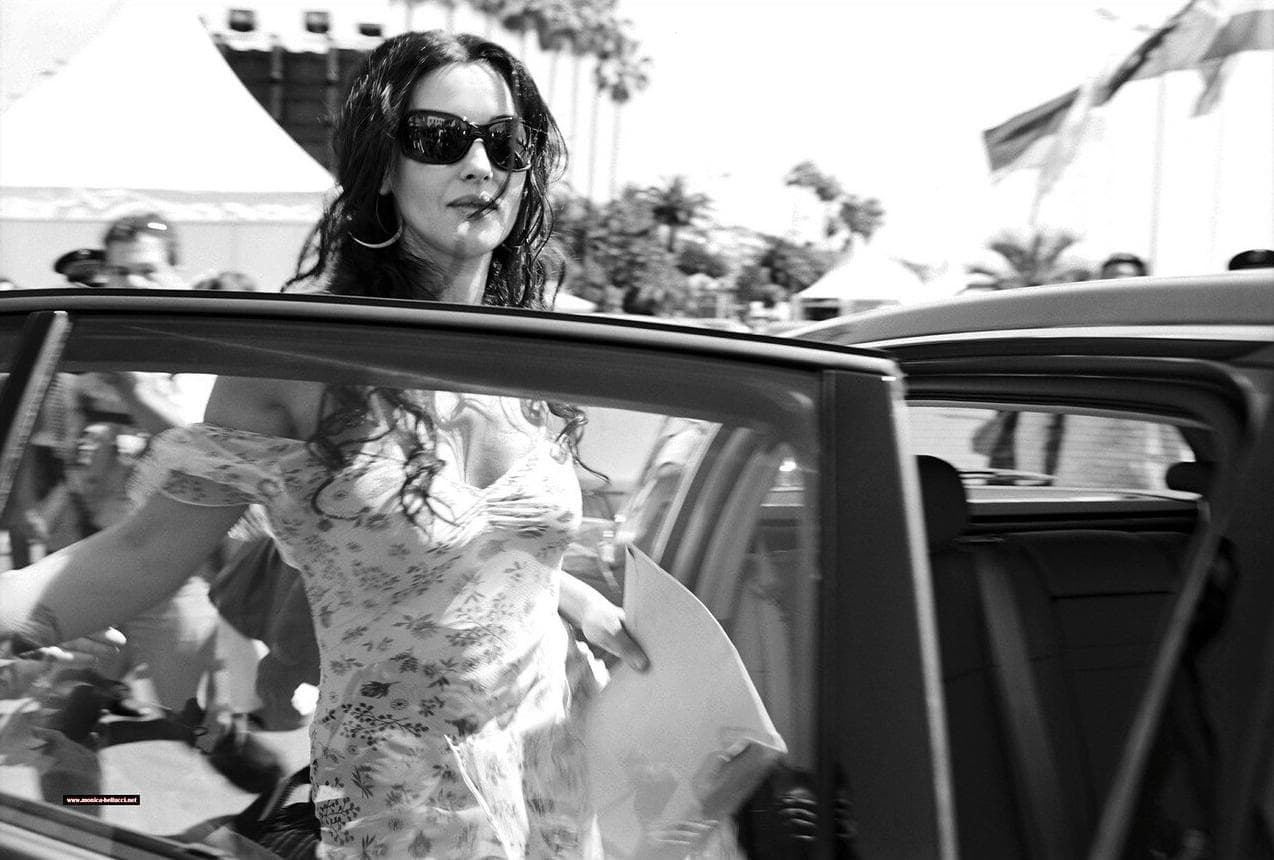 Bellucci arrives on the Croisette in sunglasses and a floral dress amid the festival crowds.