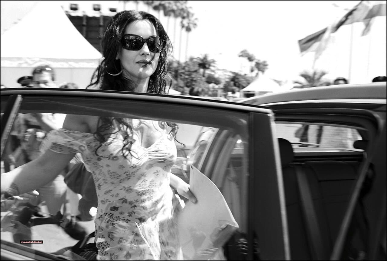 Bellucci arrives on the Croisette in sunglasses and a floral dress amid the festival crowds.
