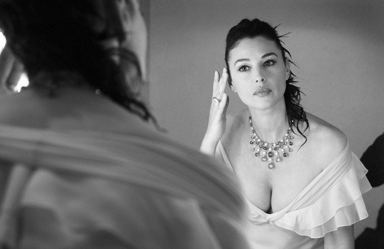 She checks her appearance in the mirror during the final dressing-room preparations.