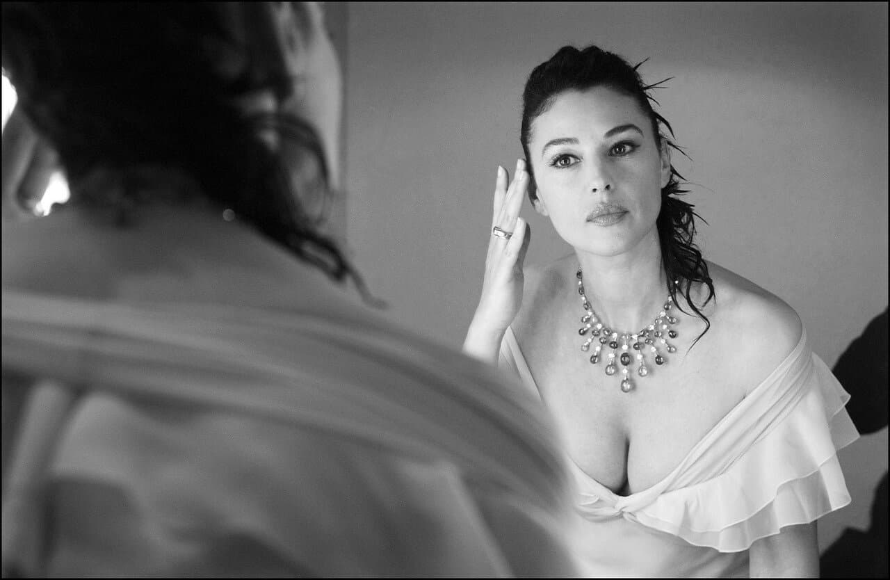 She checks her appearance in the mirror during the final dressing-room preparations.