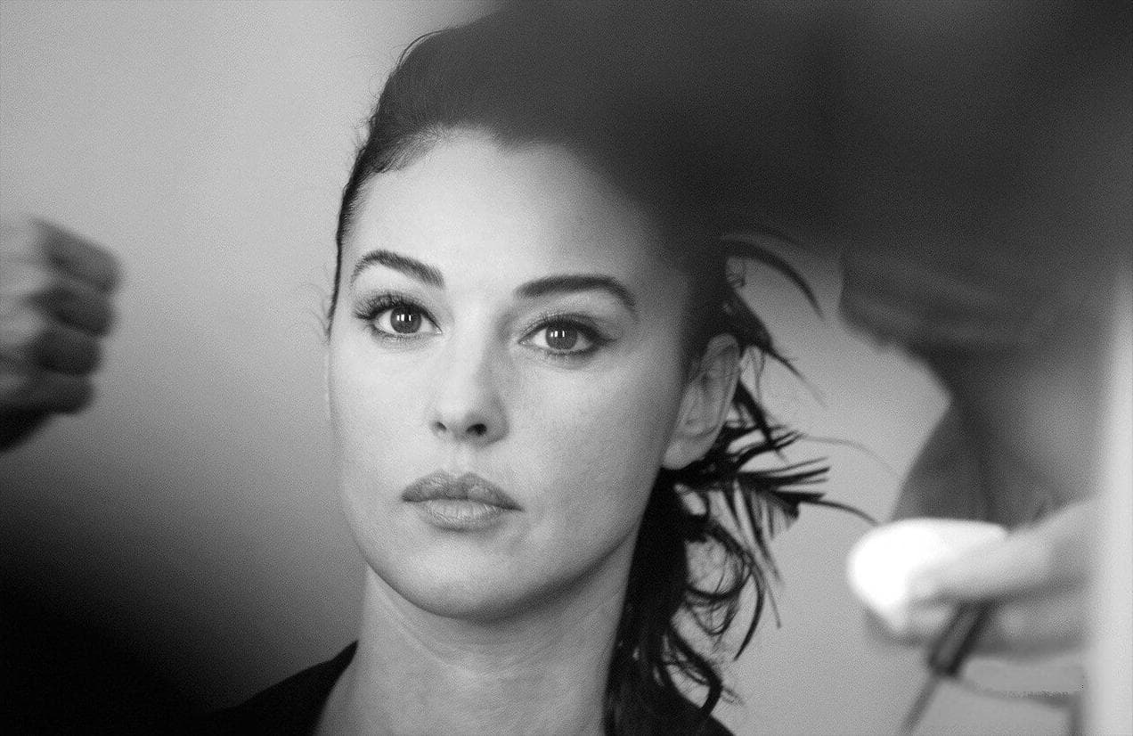 A makeup artist works beside Bellucci before her closing-ceremony appearance.