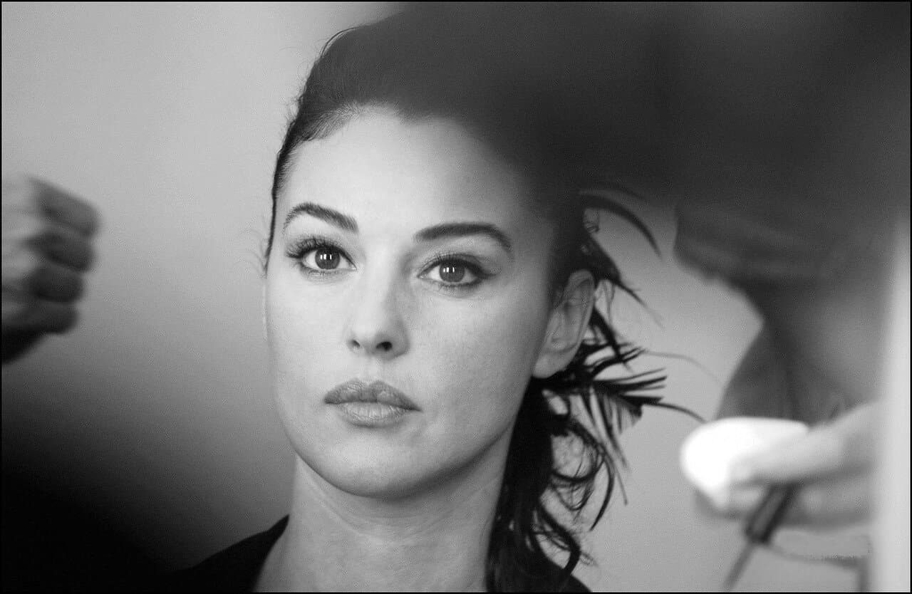 A makeup artist works beside Bellucci before her closing-ceremony appearance.