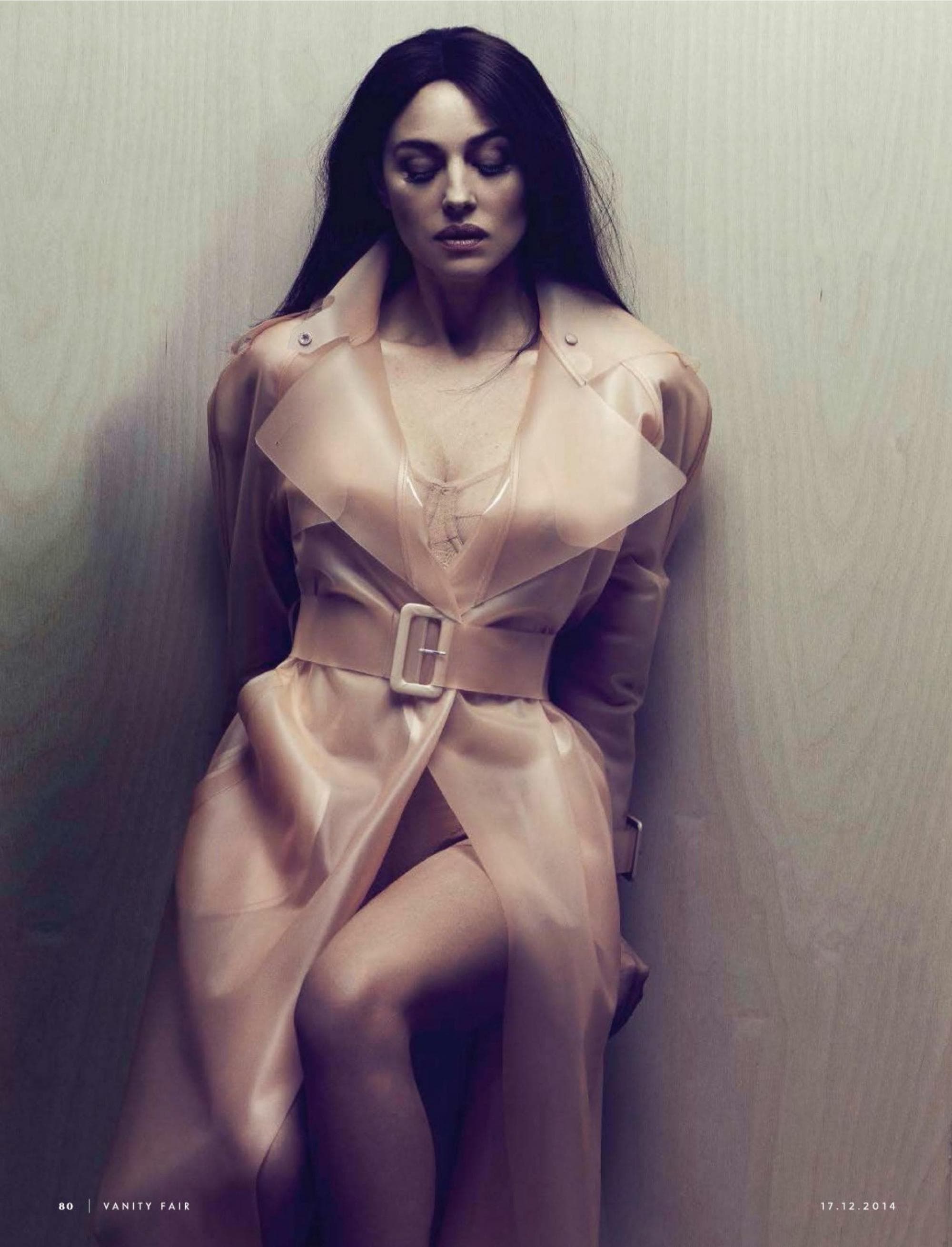 Bellucci poses in a pale belted ensemble for the December 2014 fashion story photographed by Driu & Tiago.