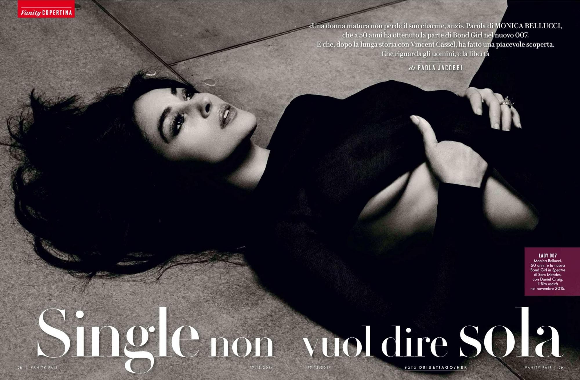 The black-and-white magazine spread frames Bellucci in a dramatic reclining portrait.