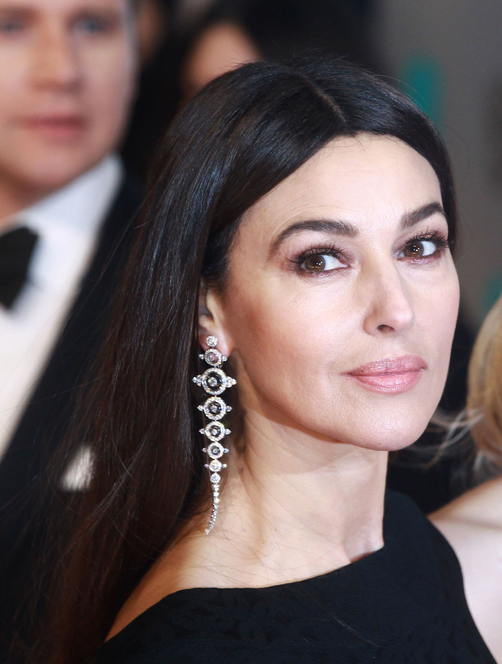 At the 2015 BAFTAs, Monica Bellucci wears Boucheron diamond earrings with an Azzedine Alaïa dress.