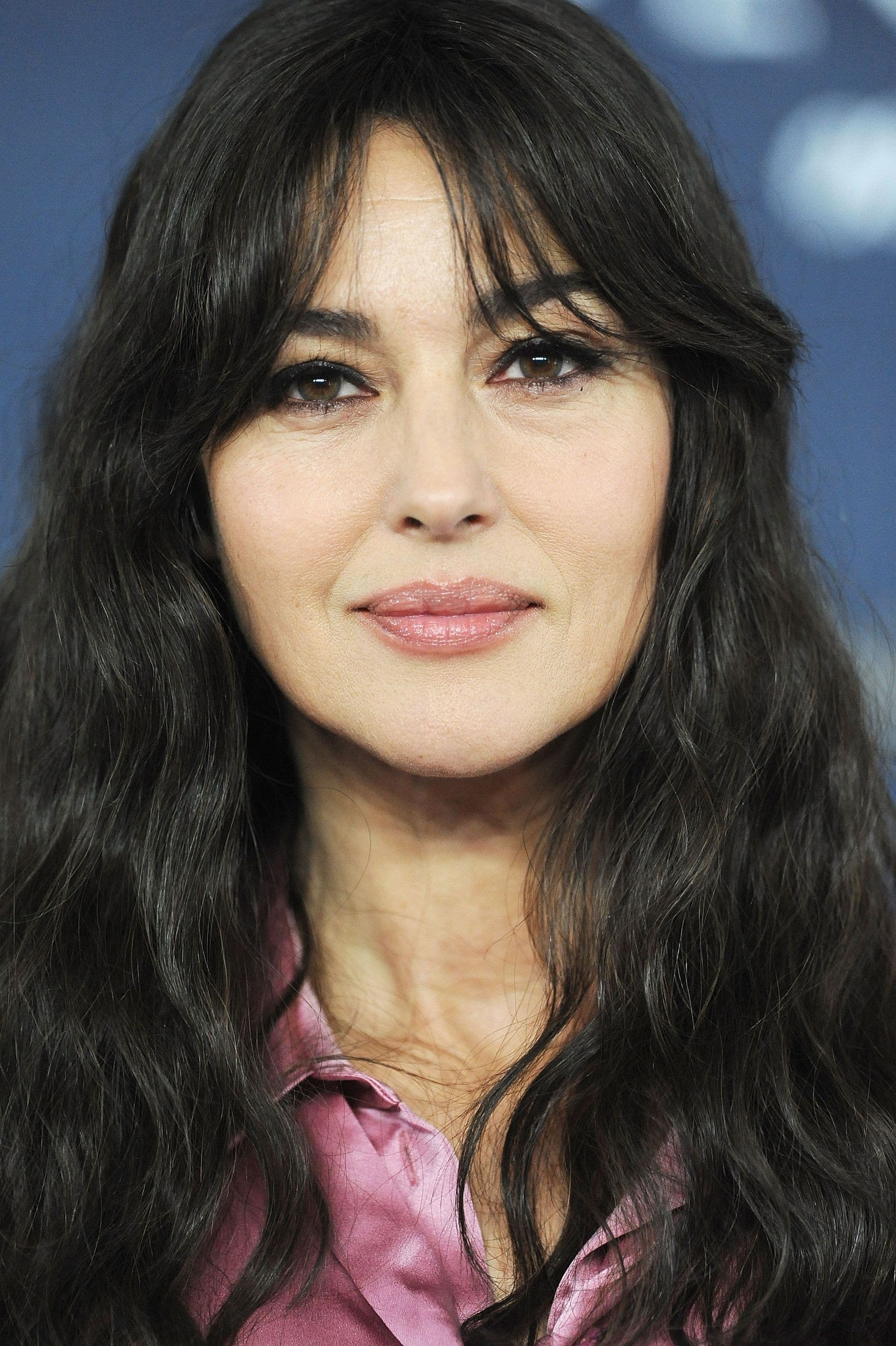 Monica Bellucci in October 2015, wearing her dark hair in smooth waves with a rich, cinematic makeup palette.