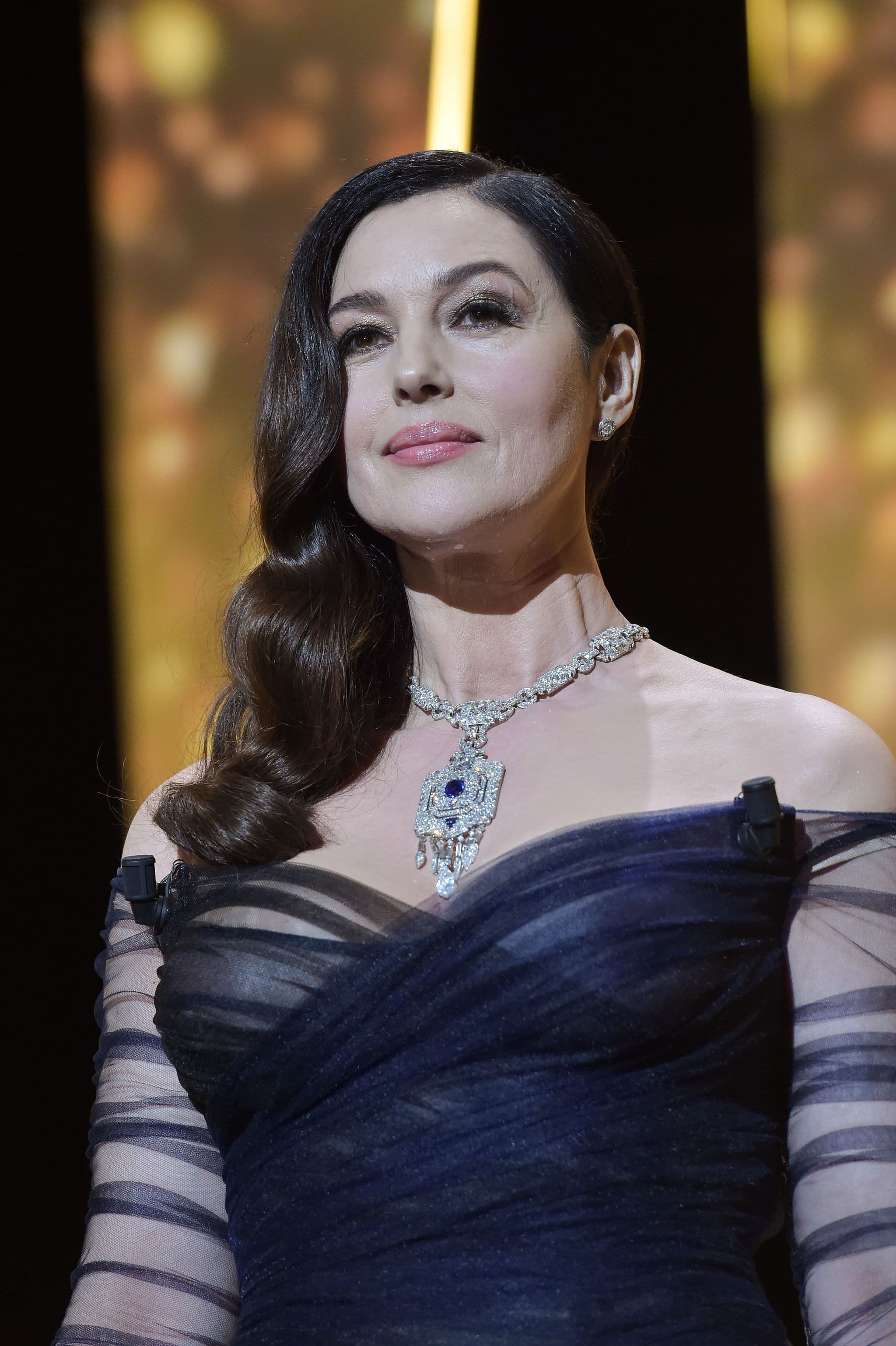 Bellucci pairs navy Dior Couture tulle with a platinum, sapphire and diamond necklace by Cartier.