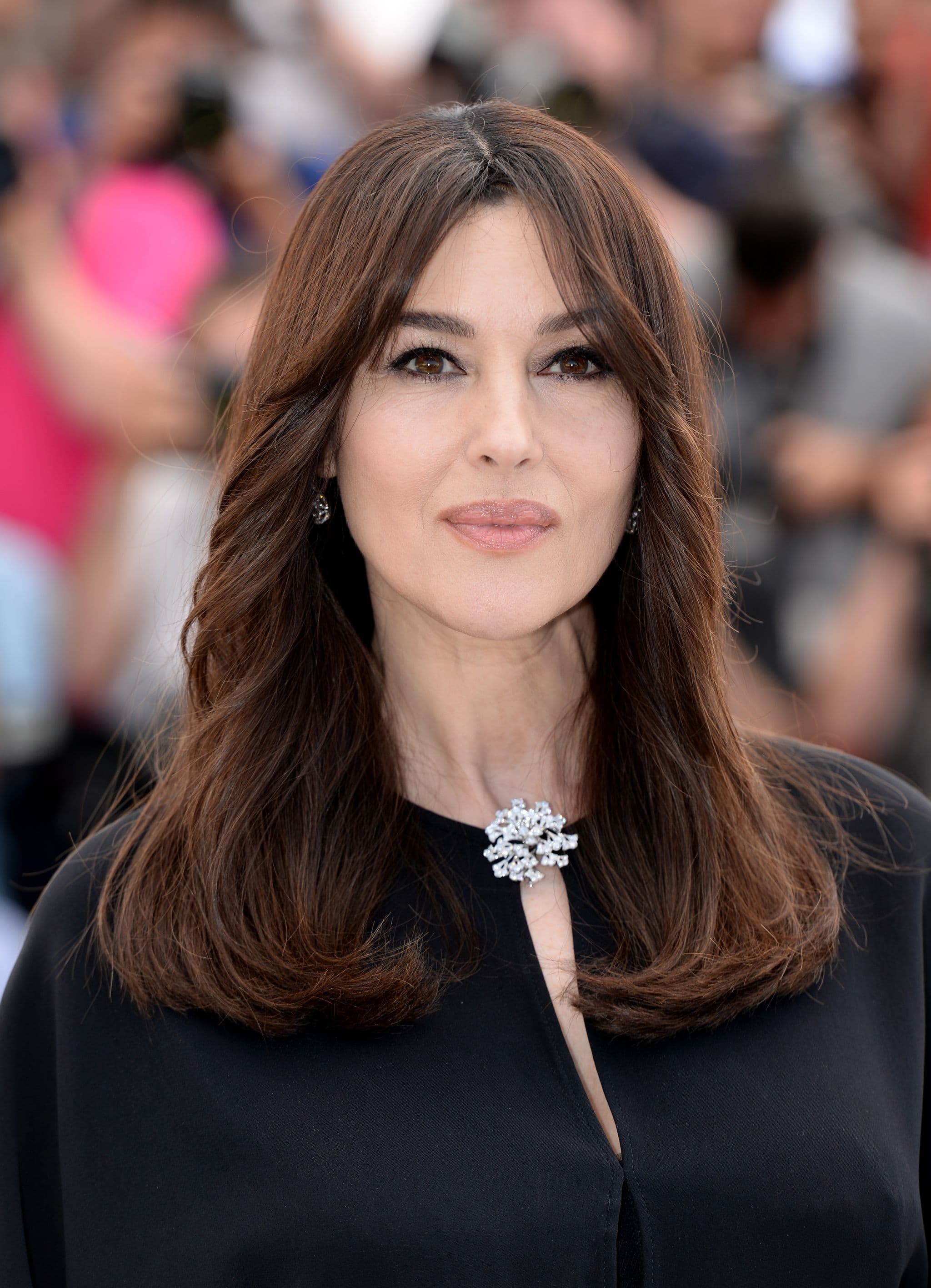 At Cannes, a luminous diamond brooch punctuates the neckline of Bellucci's black Stella McCartney jumpsuit.