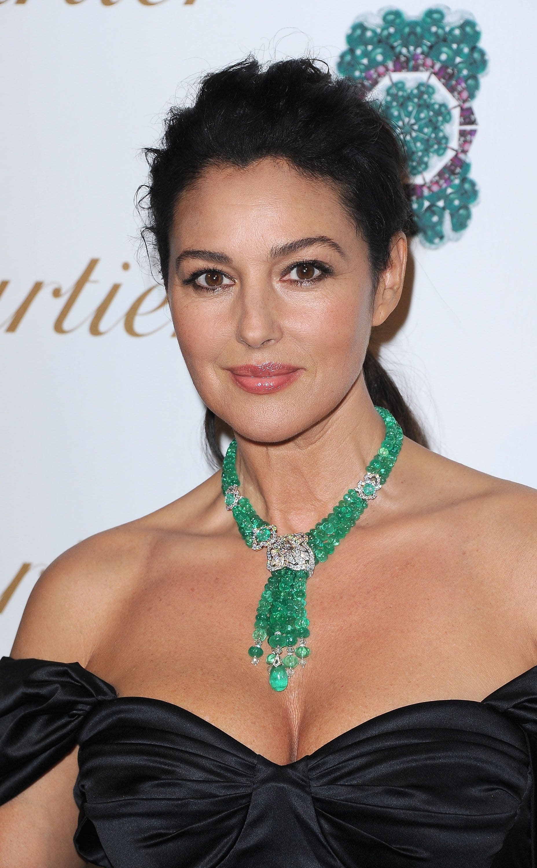 For a Cartier launch in Rome, Monica Bellucci chooses a dramatic emerald-and-diamond necklace.