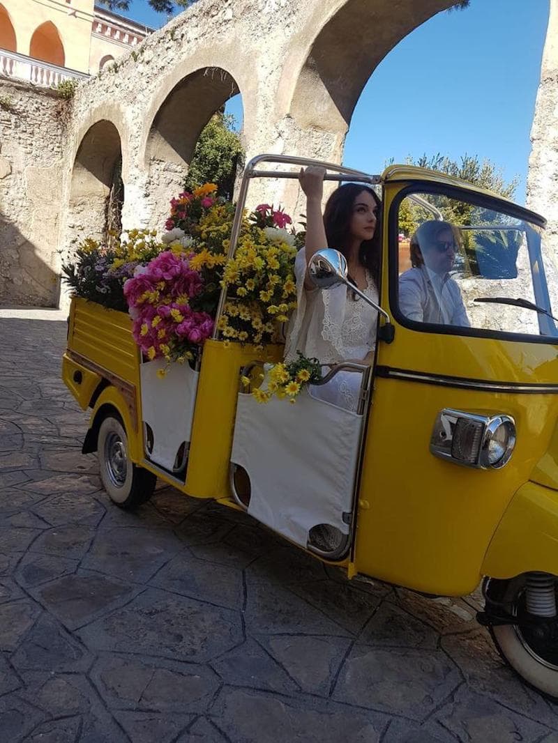 On the backstage footage the Deva poses in a small bright yellow pickup truck whose body is filled to the brim with vibrant colors.